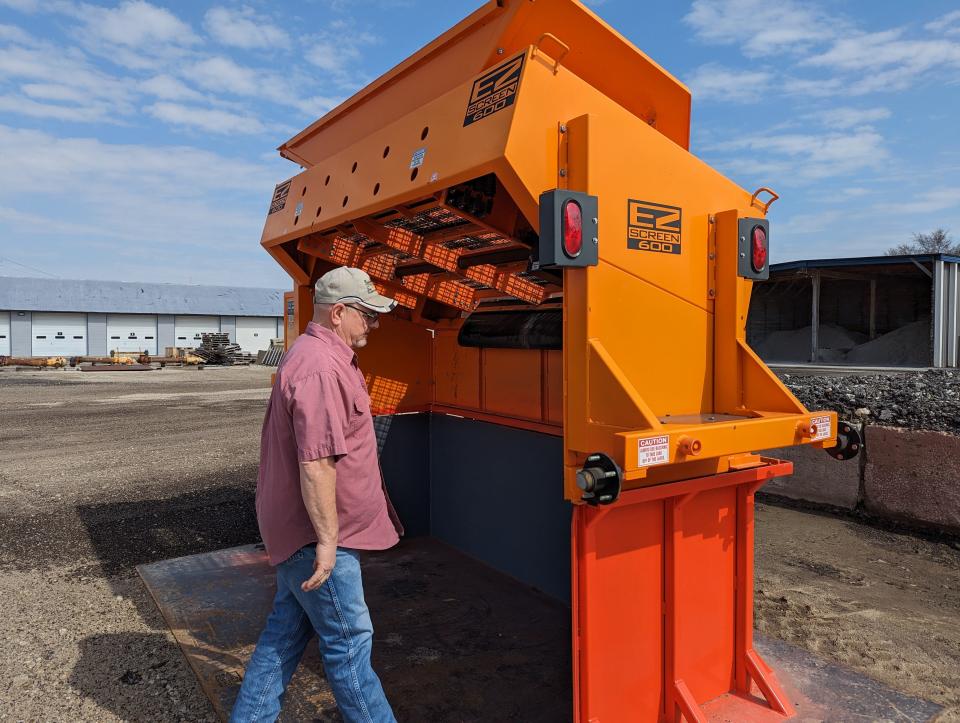 Fremont Water and Sewer Maintenance Department Supervisor Bob Ward Jr. shows the asphalt grinding system his department designed to help save money during repair situations that involve roads.