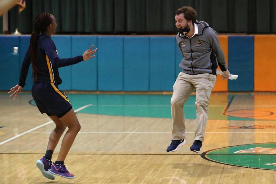 St. Thomas Aquinas’ Samara Spencer and head coach Oliver Berens celebrate after beating Blanche Ely during the regional semifinal in Pompano Beach, Tuesday, Feb. 16, 2021. ...SOUTH FLORIDA OUT; NO MAGS; NO SALES; NO INTERNET; NO TV...