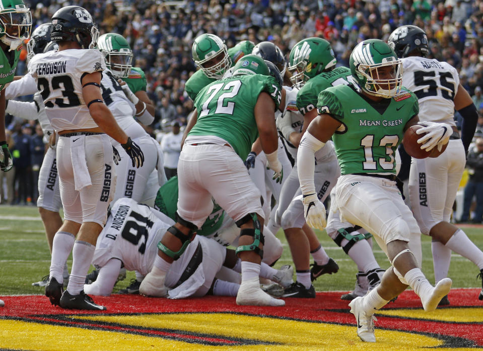 North Texas running back DeAndre Torrey (13) scores a touchdown against Utah State during the first half of the New Mexico Bowl NCAA college football game in Albuquerque, N.M., Saturday, Dec. 15, 2018. (AP Photo/Andres Leighton)