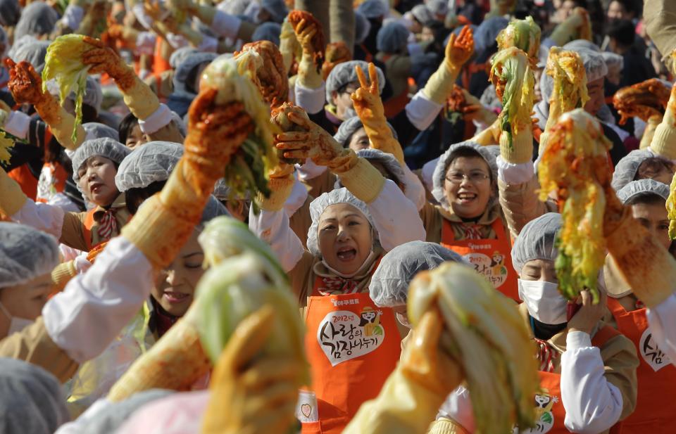 SEOUL, SOUTH KOREA - NOVEMBER 15: More than two thousands of housewives make Kimchi for donation to the poor in preparation for winter in front of City Hall on November 15, 2012 in Seoul, South Korea. Kimchi is a traditional Korean dish of fermented vegetables usually mixed with chili and eaten with rice or served as a side dish to a main meal. (Photo by Chung Sung-Jun/Getty Images)