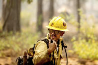 A firefighter mops up hot spots in the Trail of 100 Giants grove of Sequoia National Forest, Calif., on Monday, Sept. 20, 2021. (AP Photo/Noah Berger)