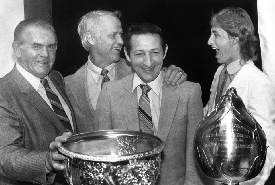 Wayne Gretzky, right, laughs with Gordie Howe, second from left, as Maurice "Rocket" Richard, left, and Walter Gretzky look on at the NHL awards ceremony in Montreal, in this June 7, 1983, photo. Walter Gretzky has died. He was 82. Wayne Gretzky said in a statement Thursday night, March 4, 2021, that his father battled Parkinson's disease and other health issues the past few years. Walter was celebrated for far more than just fathering a superstar. His down-to-earth, no-airs approach to life and devotion to his family struck a chord with Canadians. (Bill Grimshaw/The Canadian Press via AP)