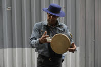 A street musician performs at the old main bazaar in Tehran, Iran, Tuesday, April 16, 2024. Israel says it is poised to retaliate against Iran, risking further expanding the shadow war between the two foes into a direct conflict after an Iranian attack over the weekend sent hundreds of munitions into Israeli airspace. (AP Photo/Vahid Salemi)