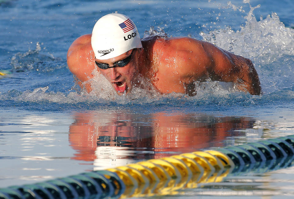 Ryan Lochte competes in the 100-meter butterfly final during the Arena Grand Prix swim meet, Thursday, April 24, 2014, in Mesa, Ariz. Lochte won, and Michael Phelps finished in second place. Phelps was competing for the first time since the 2012 London Olympics. (AP Photo/Matt York)