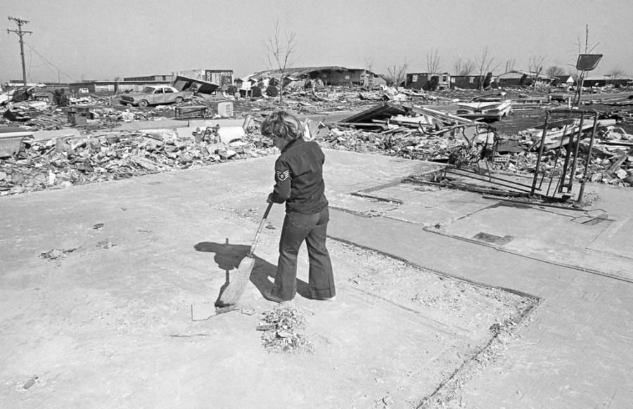 FILE – Mike Muney, 7, sweeps off the slab of a neighbor’s house that was demolished by the early April 1974 storm in Xenia, Ohio, April 19, 1974. The deadly tornado killed 32 people, injured hundreds and leveled half the city of 25,000. Nearby Wilberforce was also hit hard. As the Watergate scandal unfolded in Washington, President Richard Nixon made an unannounced visit to Xenia to tour the damage. Xenia’s was the deadliest and most powerful tornado of the 1974 Super Outbreak. (AP Photo, file)