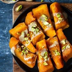 Tahini and pistachios on top of sliced pumpkins