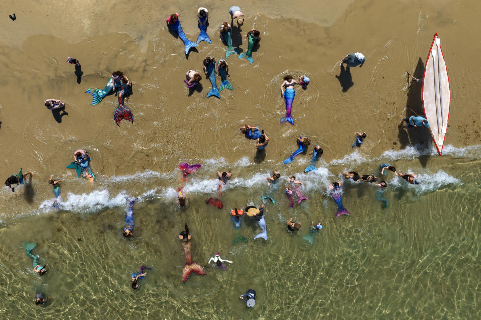 Members of the Israeli Mermaids Community swim with their mermaid tails at the Mediterranean Sea in Bat Yam, near Tel Aviv, Israel, Friday, July 21, 2023. (AP Photo/Oded Balilty)