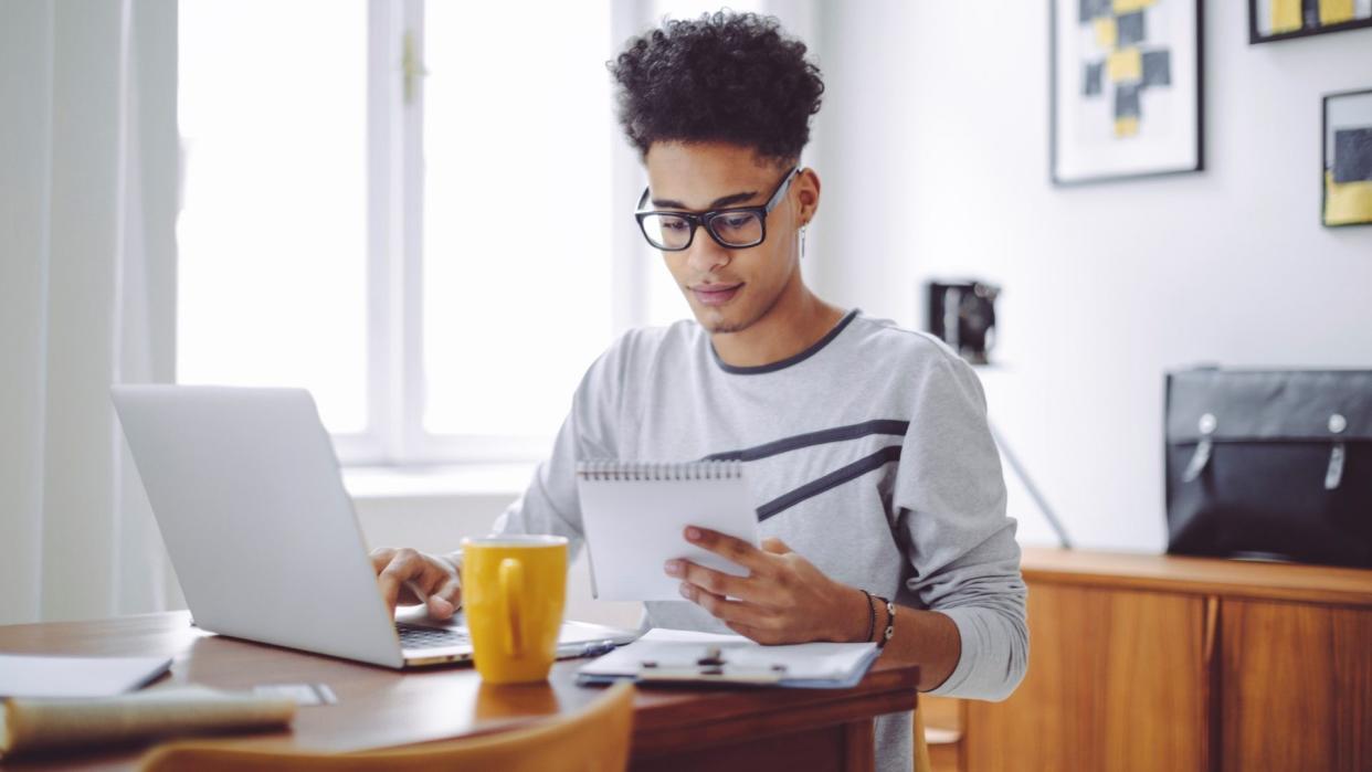 Young man working at home office.