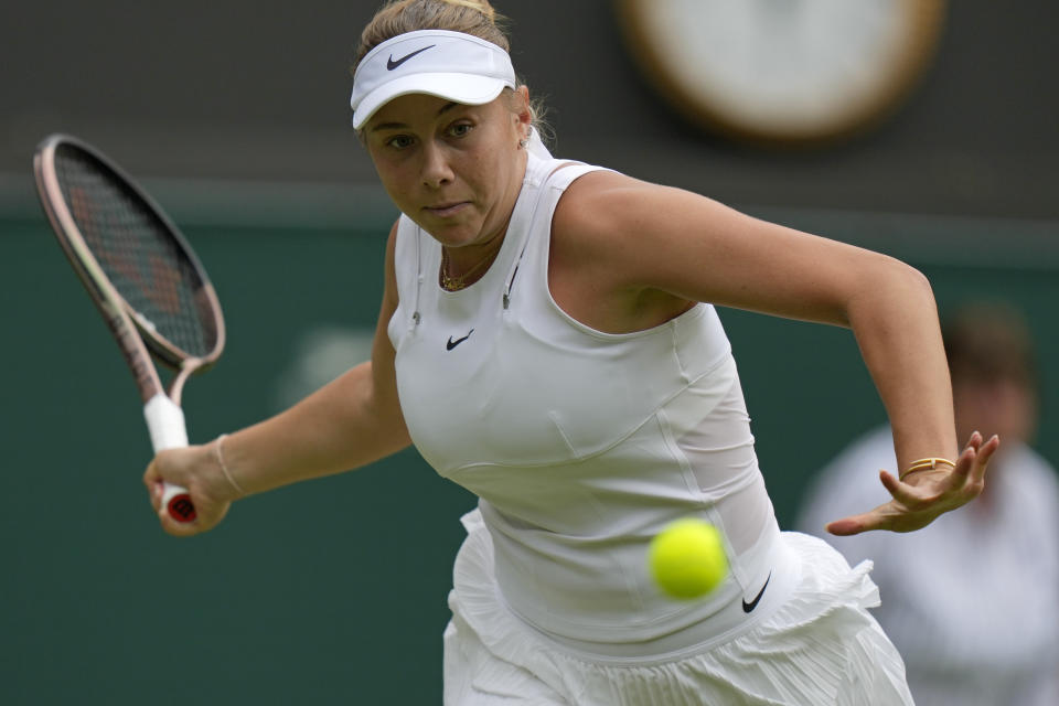 Amanda Anisimova of the US returns to France's Harmony Tan in a women's fourth round singles match on day eight of the Wimbledon tennis championships in London, Monday, July 4, 2022. (AP Photo/Alastair Grant)