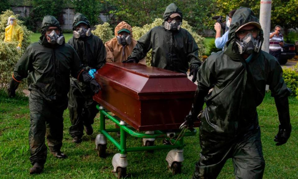Gravediggers carry a coffin during a funeral at the Jardines del Recuerdo Cemetery in Managua on Friday amid the coronavirus pandemic.