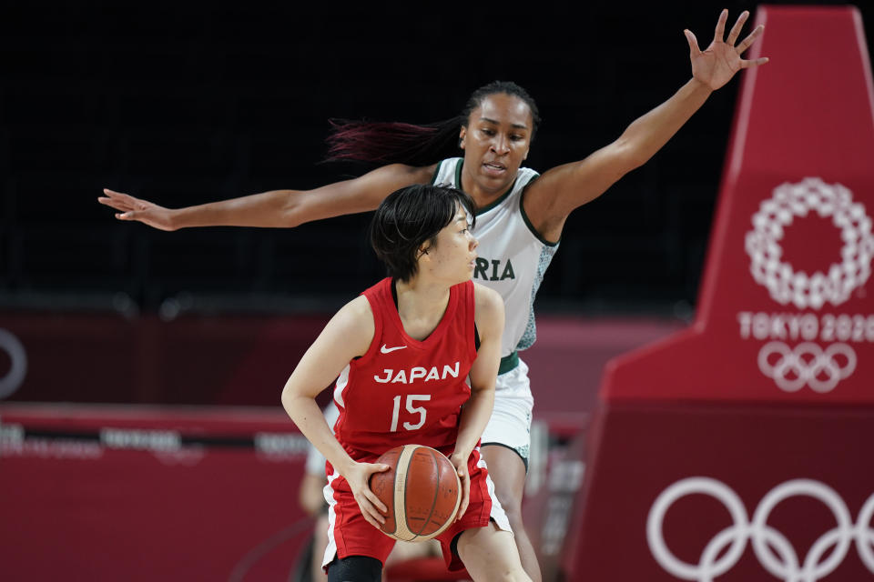 Japan's Nako Motohashi (15), front, drives around Nigeria's Oderah Chidom (22) during women's basketball preliminary round game at the 2020 Summer Olympics, Monday, Aug. 2, 2021, in Saitama, Japan. (AP Photo/Eric Gay)