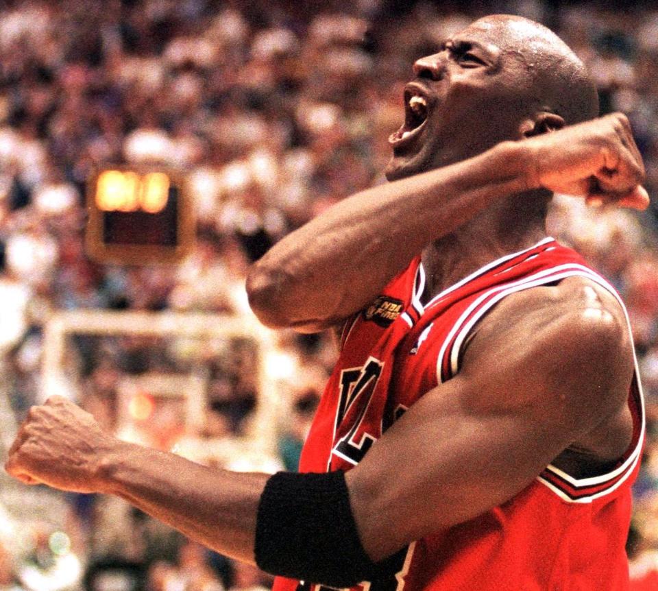 Michael Jordan celebrates after winning Game 6 of the NBA Finals on June 14, 1998. (Photo credit should read ROBERT SULLIVAN/AFP via Getty Images)