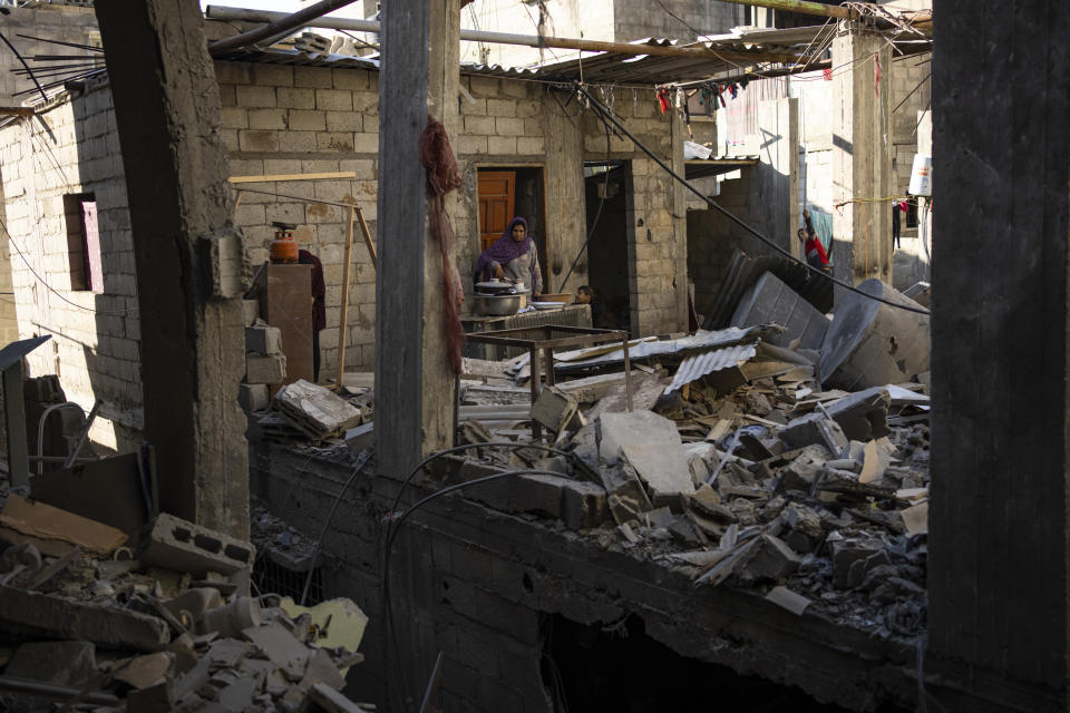 Palestinians look at the destruction after an Israeli strike in Rafah, southern Gaza Strip, Thursday, Feb. 8, 2024. (AP Photo/Fatima Shbair)