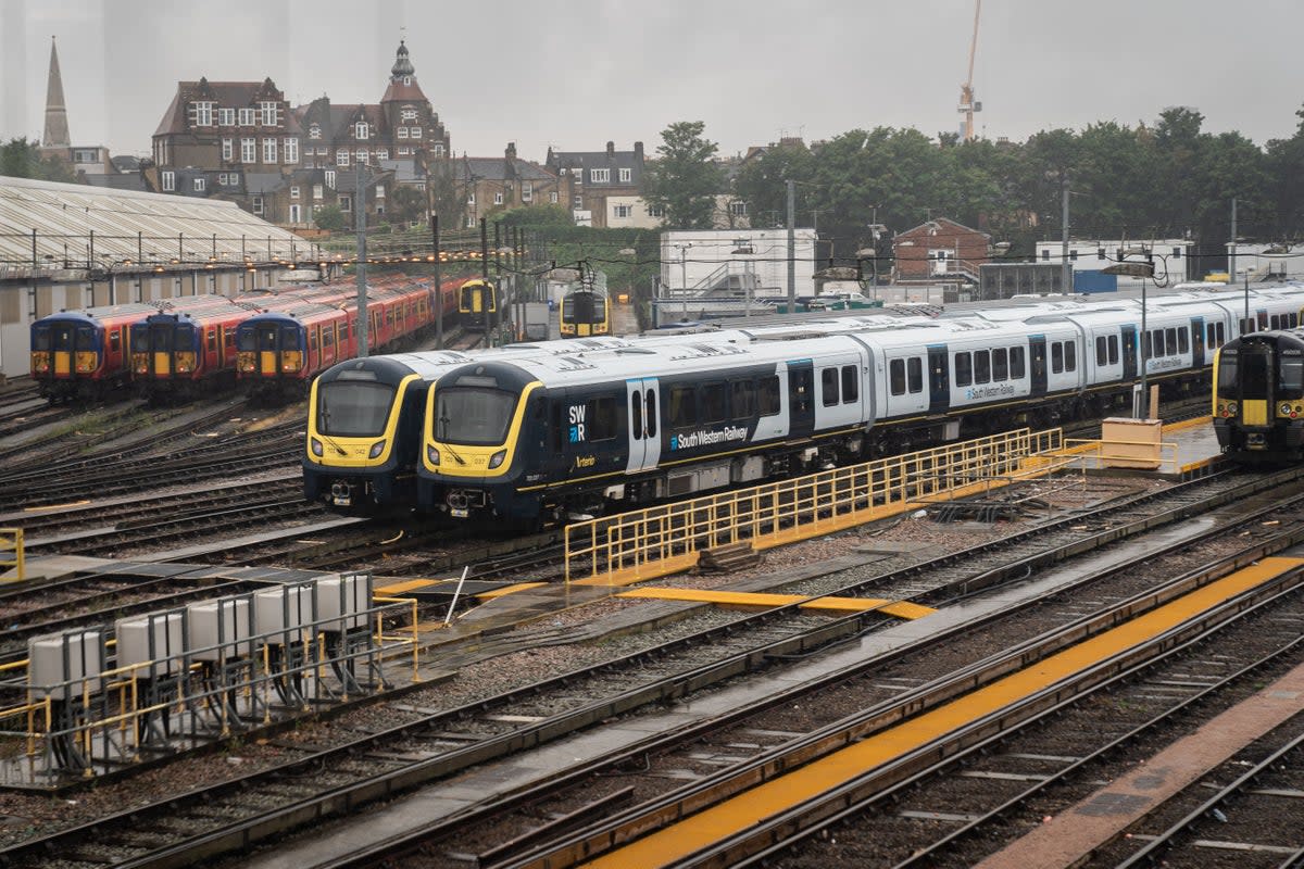 Trains parked up on tracks at Clapham Junction Station (PA)