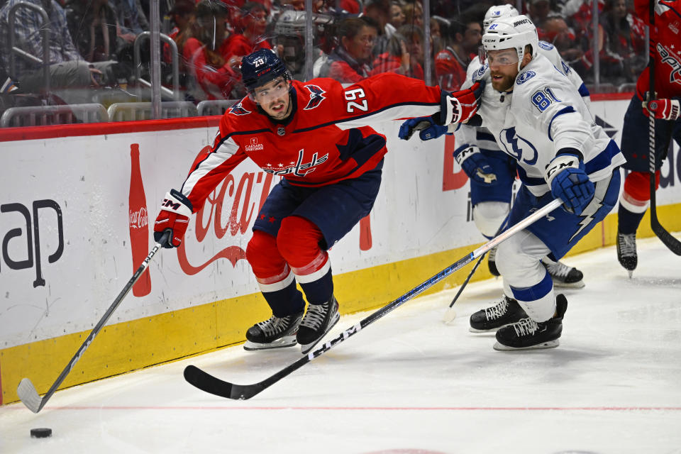 Washington Capitals center Hendrix Lapierre (29) gains control of the puck against Tampa Bay Lightning defenseman Erik Cernak (81) during the second period of an NHL hockey game Saturday, April 13, 2024, in Washington. (AP Photo/John McDonnell)