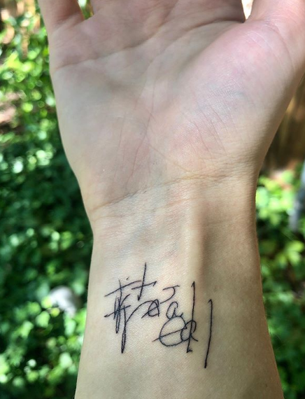 A photo of Madie Johnson's wrist tattoo that says "it's real."