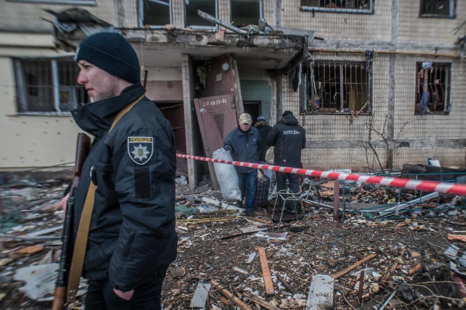 People try to save what is left of their belongings after a rocket hit their house on the outskirts of Kyiv (Alina Smutko)