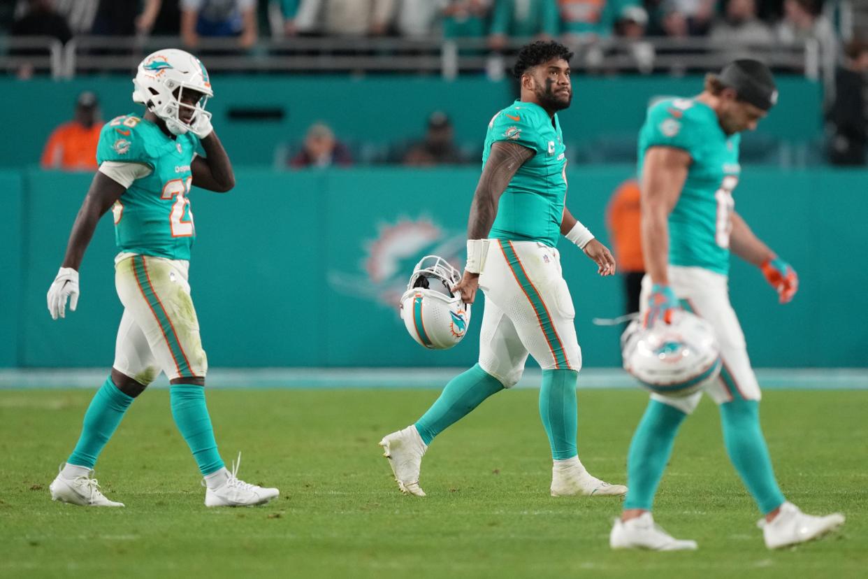 Miami Dolphins quarterback Tua Tagovailoa, center, walks off the field after getting sacked on fourth down against the Tennessee Titans late in the game at Hard Rock Stadium in Miami Gardens, Dec. 11, 2023.