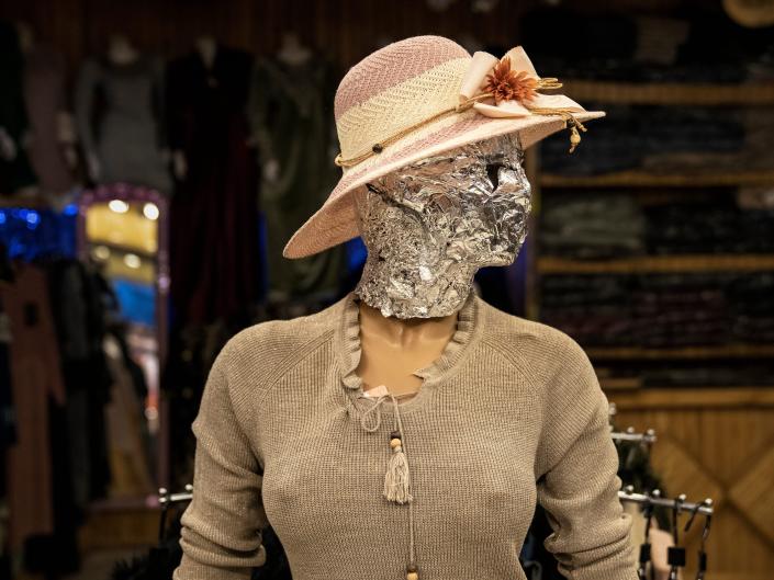 A mannequin head is covered at a women's dress shop in Kabul, Afghanistan, Monday, December 26, 2022.