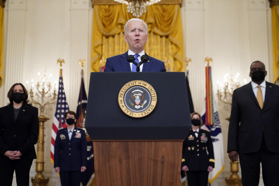 President Joe Biden speaks during an event to mark International Women's Day, Monday, March 8, 2021, in the East Room of the White House in Washington, as Vice President Kamala Harris and Defense Secretary Lloyd Austin listen. (AP Photo/Patrick Semansky)