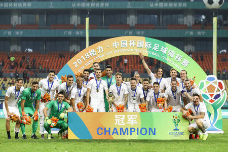 Football Soccer - Wales v Uruguay - China Cup Finals - Guangxi Sports Center, Nanning, China - March 26, 2018. Uruguay players pose with the trophy and medals after winning the cup. REUTERS/Stringer