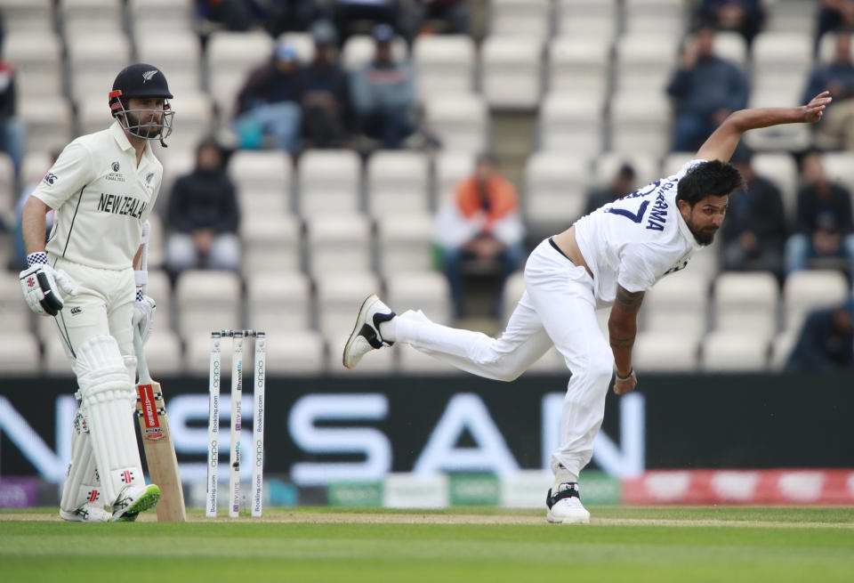 New Zealand's captain Kane Williamson, left, looks on as India's Ishant Sharma, right, bowls a delivery during the fifth day of the World Test Championship final cricket match between New Zealand and India, at the Rose Bowl in Southampton, England, Tuesday, June 22, 2021. (AP Photo/Ian Walton)