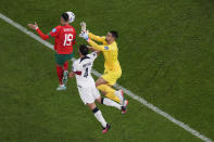 Morocco's Youssef En-Nesyri , left, heads the ball to score the opening goal next to Portugal's goalkeeper Diogo Costa, right, during the World Cup quarterfinal soccer match between Morocco and Portugal, at Al Thumama Stadium in Doha, Qatar, Saturday, Dec. 10, 2022. (AP Photo/Thanassis Stavrakis)