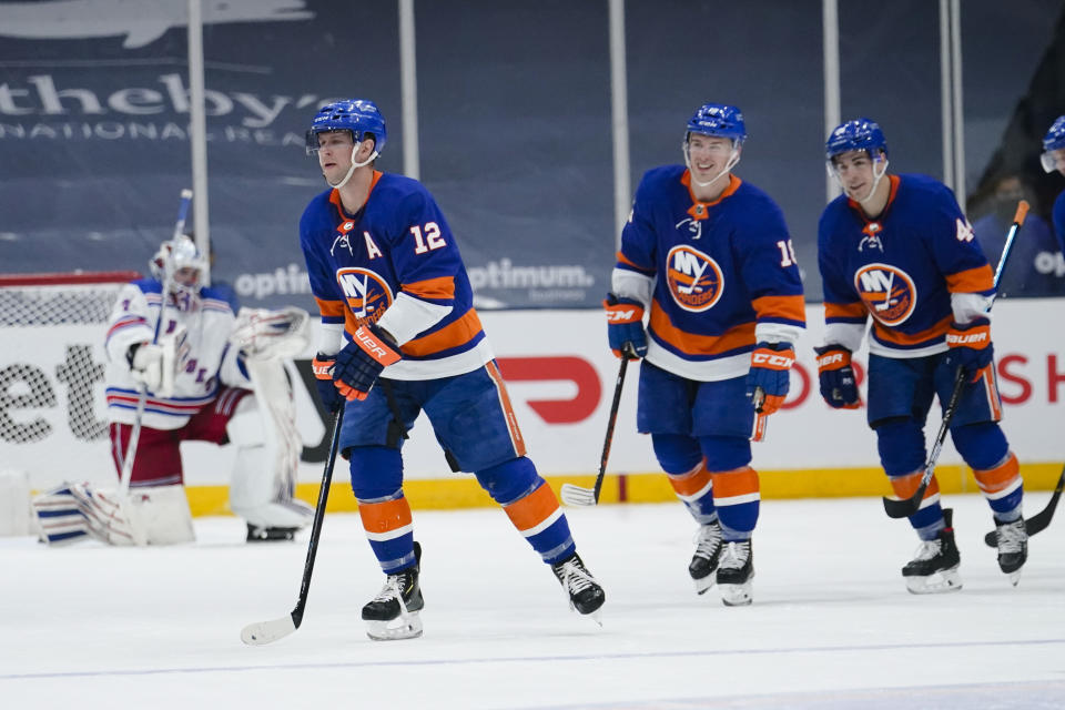 New York Islanders' Josh Bailey (12), Anthony Beauvillier (18) and Jean-Gabriel Pageau (44) skate past New York Rangers goaltender Igor Shesterkin (31) after Bailey scored a goal during the third period of an NHL hockey game Tuesday, April 20, 2021, in Uniondale, N.Y. The Islanders won 6-1. (AP Photo/Frank Franklin II)