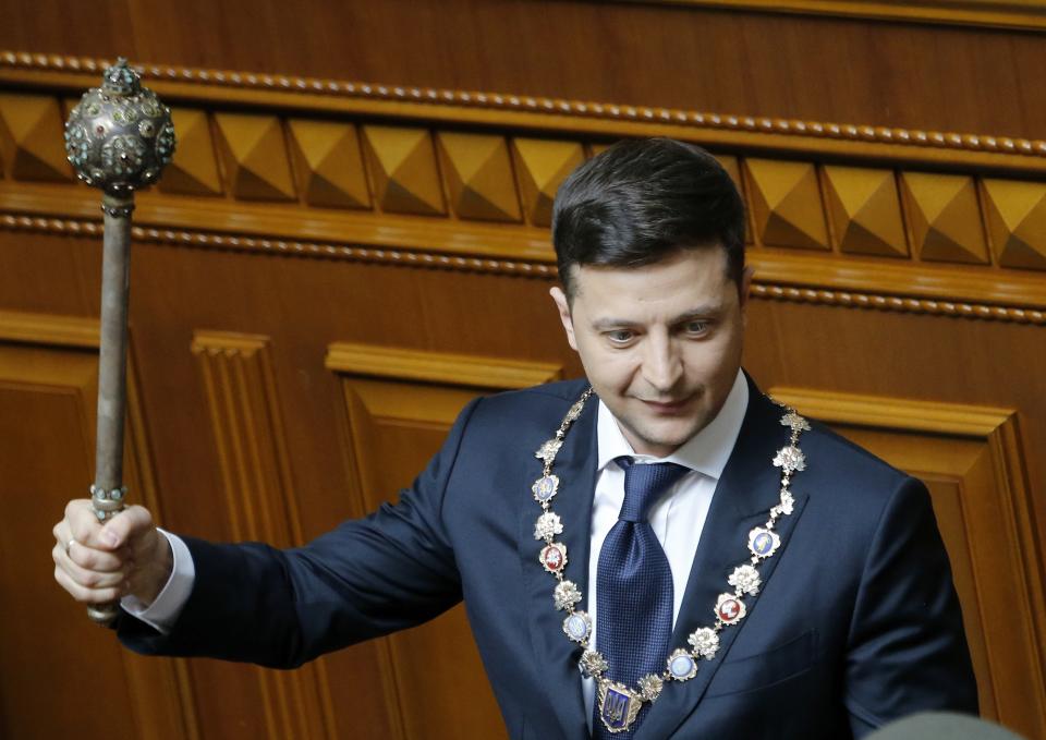 FILE Ukrainian new President Volodymyr Zelenskyy holds a mace, the Ukrainian symbol of power, during his inauguration ceremony in Kiev, Ukraine, Monday, May 20, 2019. Ukrainian television star Volodymyr Zelenskiy has been sworn in as president and immediately disbanded the Ukrainian parliament. That was one of his campaign promises, for Zelenskiy had branded the body as a group only interested in self-enrichment. (AP Photo/Efrem Lukatsky, File)