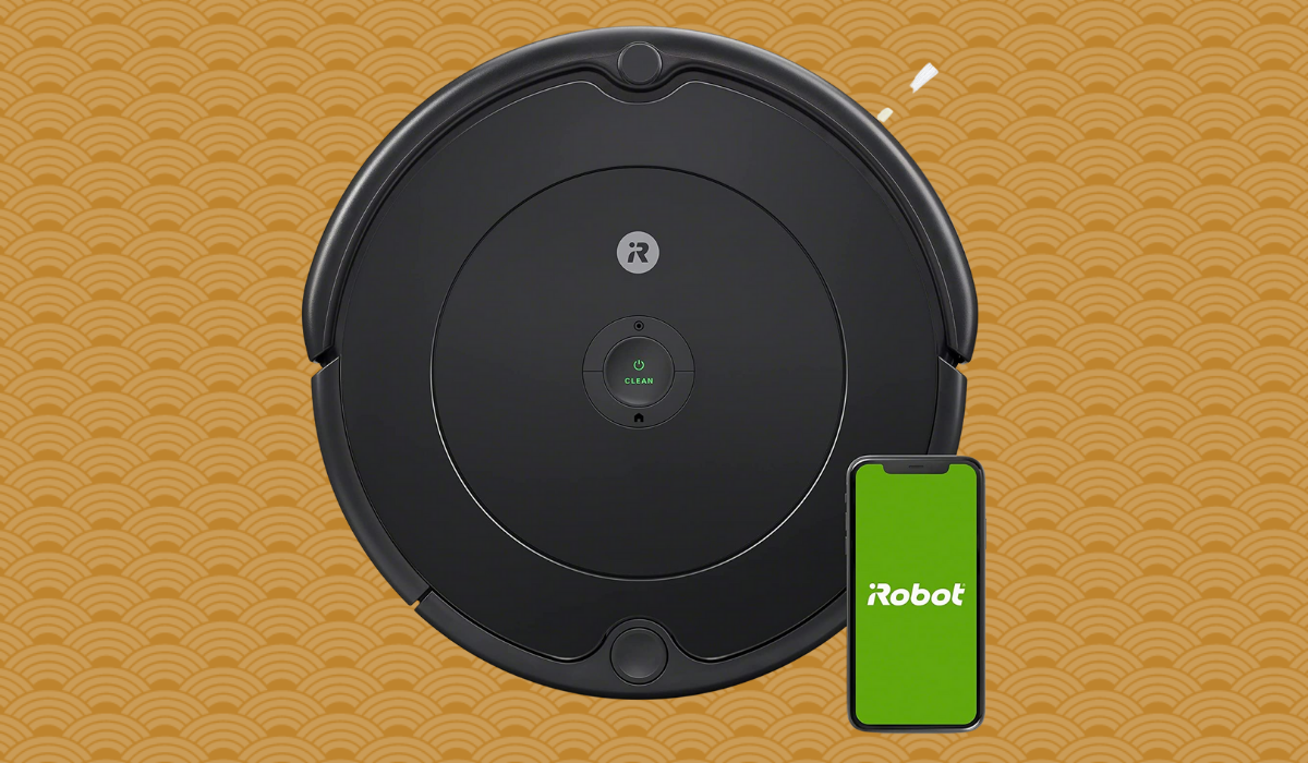 A black robot vacuum with a phone next to it reading 