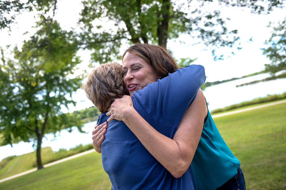 Theresa Greenfield hugs an attendee at a Democratic Party picnic this past August. Everywhere she goes, people come forward with their own stories about Social Security, the candidate said. (Photo: Caroline Brehman/Getty Images)
