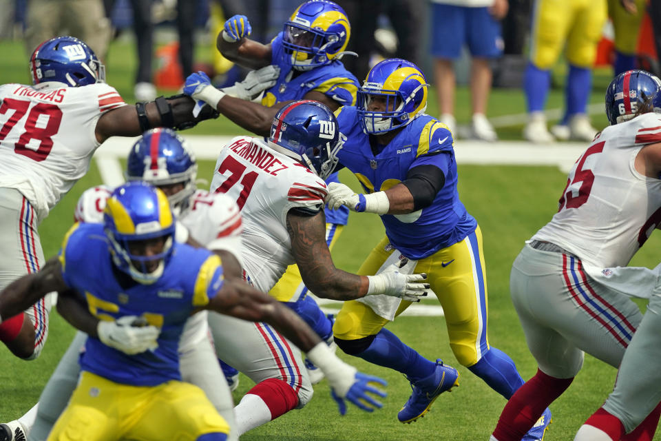 Los Angeles Rams defensive end Aaron Donald, center, works against the New York Giants during the first half of an NFL football game Sunday, Oct. 4, 2020, in Inglewood, Calif. (AP Photo/Ashley Landis)