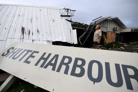 Dave Mcinnerney inspects the damage to his motel after Cyclone Debbie at Shute Harbour in the township of Airlie Beach, located south of the northern Australian city of Townsville, March 29, 2017. AAP/Dan Peled/via REUTERS