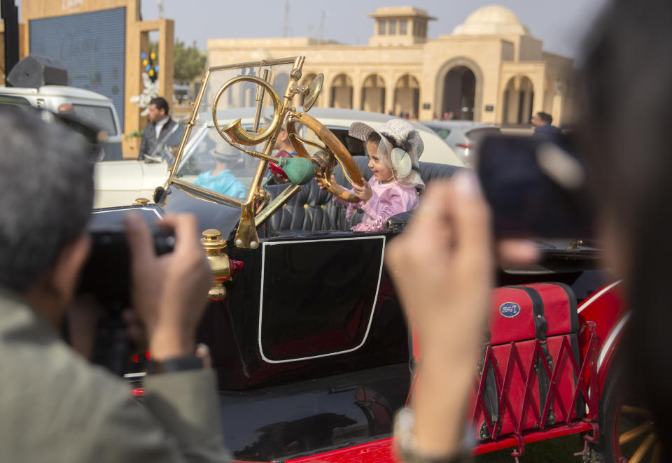 Five-year-old Samar sits for a photo in a 1924 Ford T owned by Egyptian collector Mohamed Wahdan during a classic car show in Cairo, Egypt, Saturday, March 19, 2022. The car once belonged to Egypt's King Farouk's and is a part of over 250 vintage, antique and classic cars Wahdan collected over the past 20 years. (AP Photo/Amr Nabil)