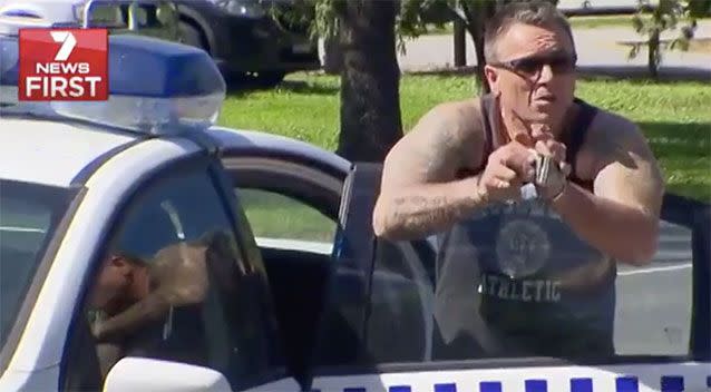 The man was arrested and handcuffed for driving while disqualified. Source: 7 News