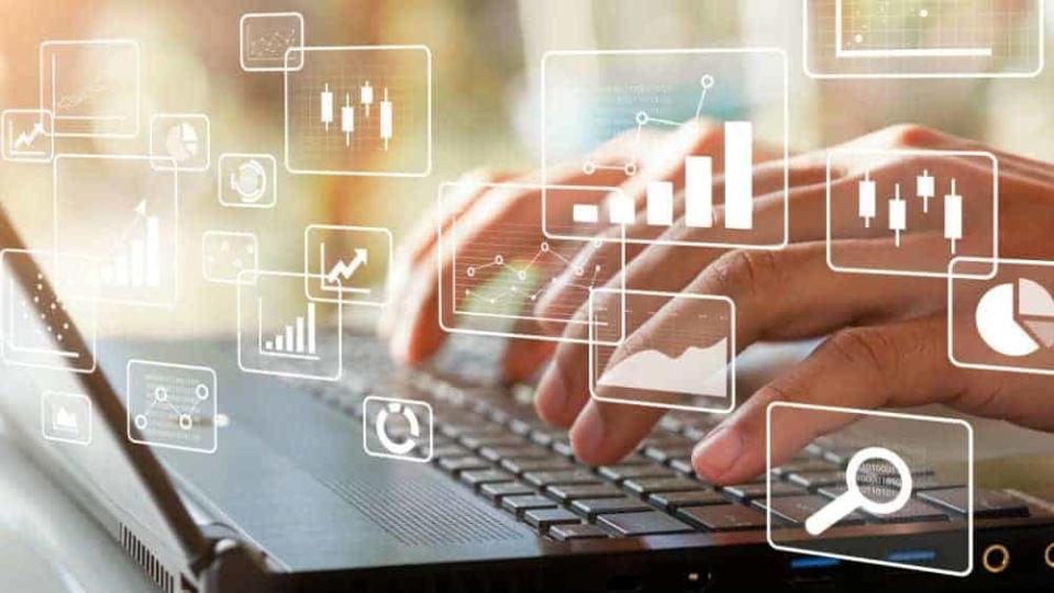 data analytics, chart and graph icons with female hands typing on laptop in background