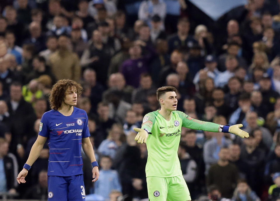 Chelsea goalkeeper Kepa Arrizabalaga, right, and Chelsea's David Luiz react during the English League Cup final soccer match between Chelsea and Manchester City at Wembley stadium in London, England, Sunday, Feb. 24, 2019. (AP Photo/Tim Ireland)
