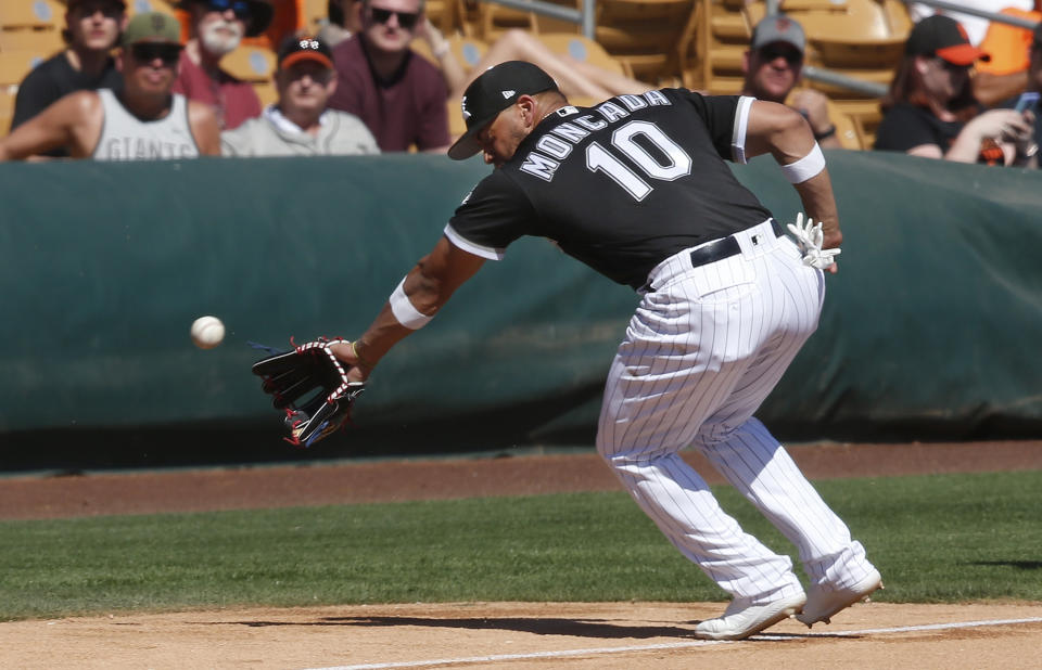 FILE - In this Monday, March 18, 2019, file photo, Chicago White Sox infielder Yoan Moncada reaches for a foul ball hit by San Francisco Giants' Pablo Sandoval in the fifth inning of a spring training baseball game in Glendale, Ariz. The White Sox are counting on young players such as infielder Yoan Moncada. (AP Photo/Sue Ogrocki, File)