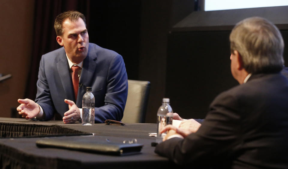 Oklahoma's Republican gubernatorial candidate Kevin Stitt, left, answers a question during a gubernatorial forum in Oklahoma City, Monday, Sept. 24, 2018. Democratic candidate Drew Edmondson is at right. (AP Photo/Sue Ogrocki)