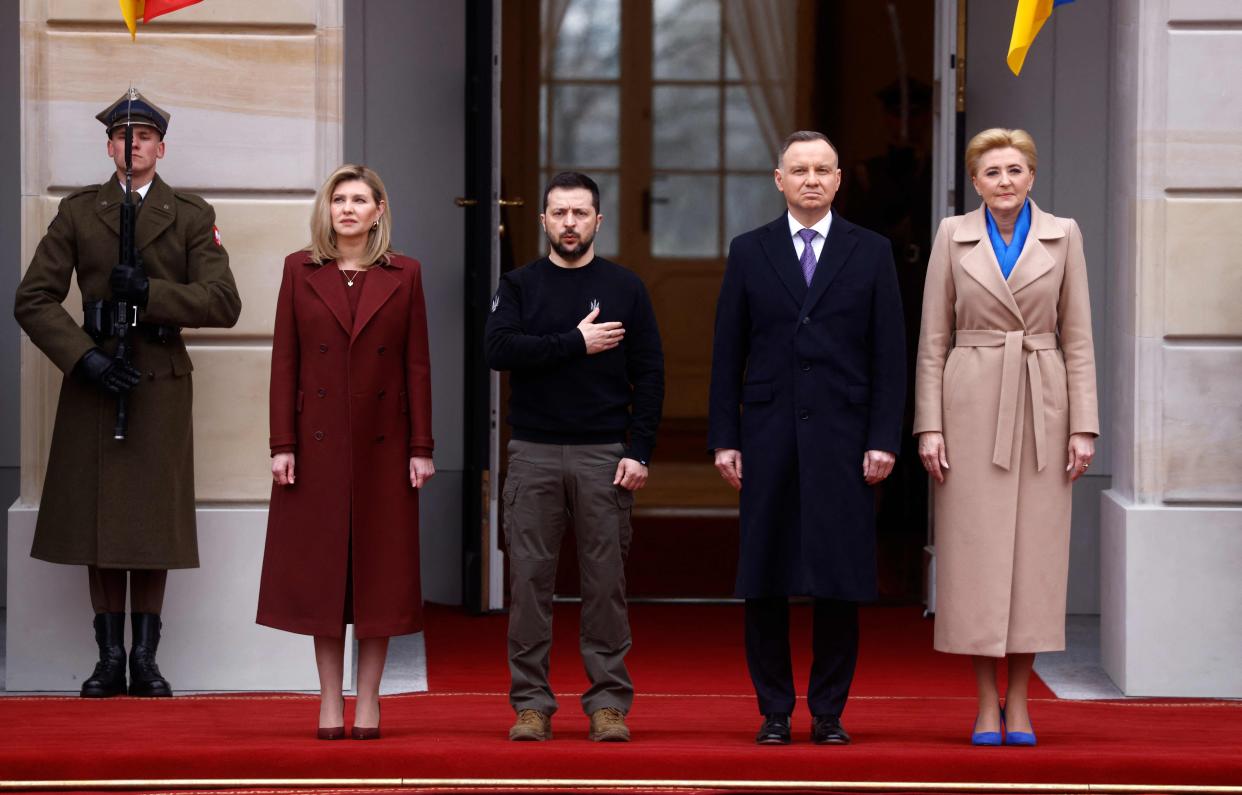 Polish President Andrzej Duda (2ndR) and his wife Agata Kornhauser-Duda (R) together with Ukrainian President Volodymyr Zelensky (C) and his wife Olena Zelenska stand during an official welcoming ceremony in front of the Presidential Palace in Warsaw, Poland (AFP via Getty Images)