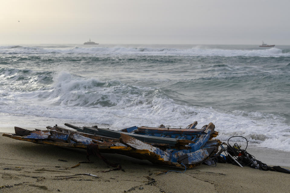 A view of the wreckage of a capsized boat that was washed ashore at a beach near Cutro, southern Italy, Monday, Feb. 27, 2023. Rescue crews searched by sea and air Monday for the dozens of people believed still missing from a shipwreck off Italy’s southern coast that drove home once again the desperate and dangerous crossings of migrants seeking to reach Europe. (AP Photo/Valeria Ferraro)