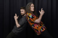 Daniel Radcliffe, left, and "Weird Al" Yankovic strike a pose together for a portrait at the Bisha Hotel, during the Toronto International Film Festival, Thursday, Sept. 8, 2022, in Toronto. Radcliffe plays Yankovic in the film "Weird: The Al Yankovic Story." (AP Photo/Chris Pizzello)