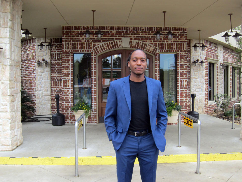 In this Friday, April 12, 2019, photo Jasper city council member Rashad Lewis stands in front of a restaurant in Jasper, Texas, after discussing the legacy of James Byrd Jr.'s death and its impact on Jasper. Byrd was killed on June 7, 1998, after he was chained to the back of a pickup truck and dragged for nearly three miles along a secluded road in the piney woods outside Jasper. John William King, the convicted ringleader of Byrd's death, is set to be executed on Wednesday, April. 24, 2019. (AP Photo/Juan Lozano)