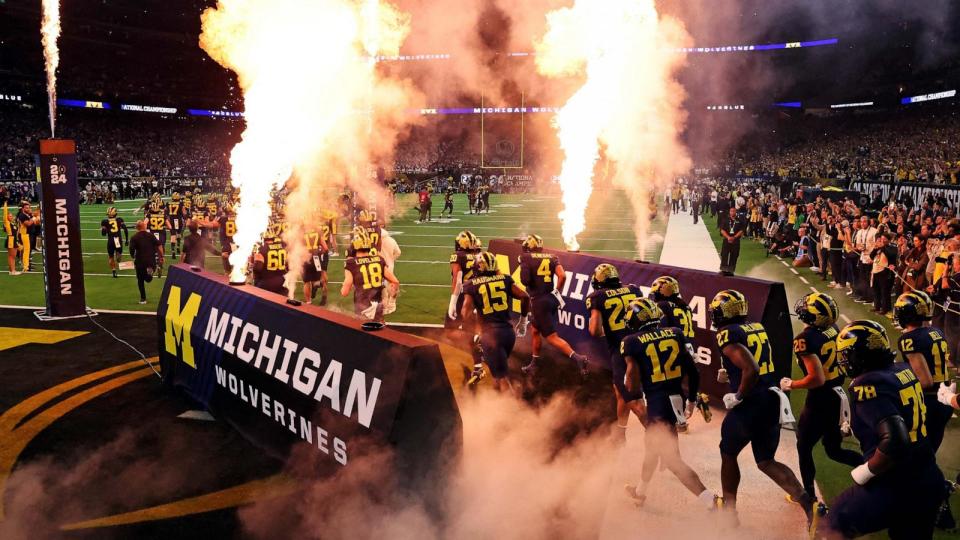 PHOTO: The Michigan Wolverines run into the field before playing against the Washington Huskies in the 2024 College Football Playoff national championship game at NRG Stadium, in Houston, Texas, Jan. 8, 2024. (Troy Taormina/USA TODAY Sports via Reuters )