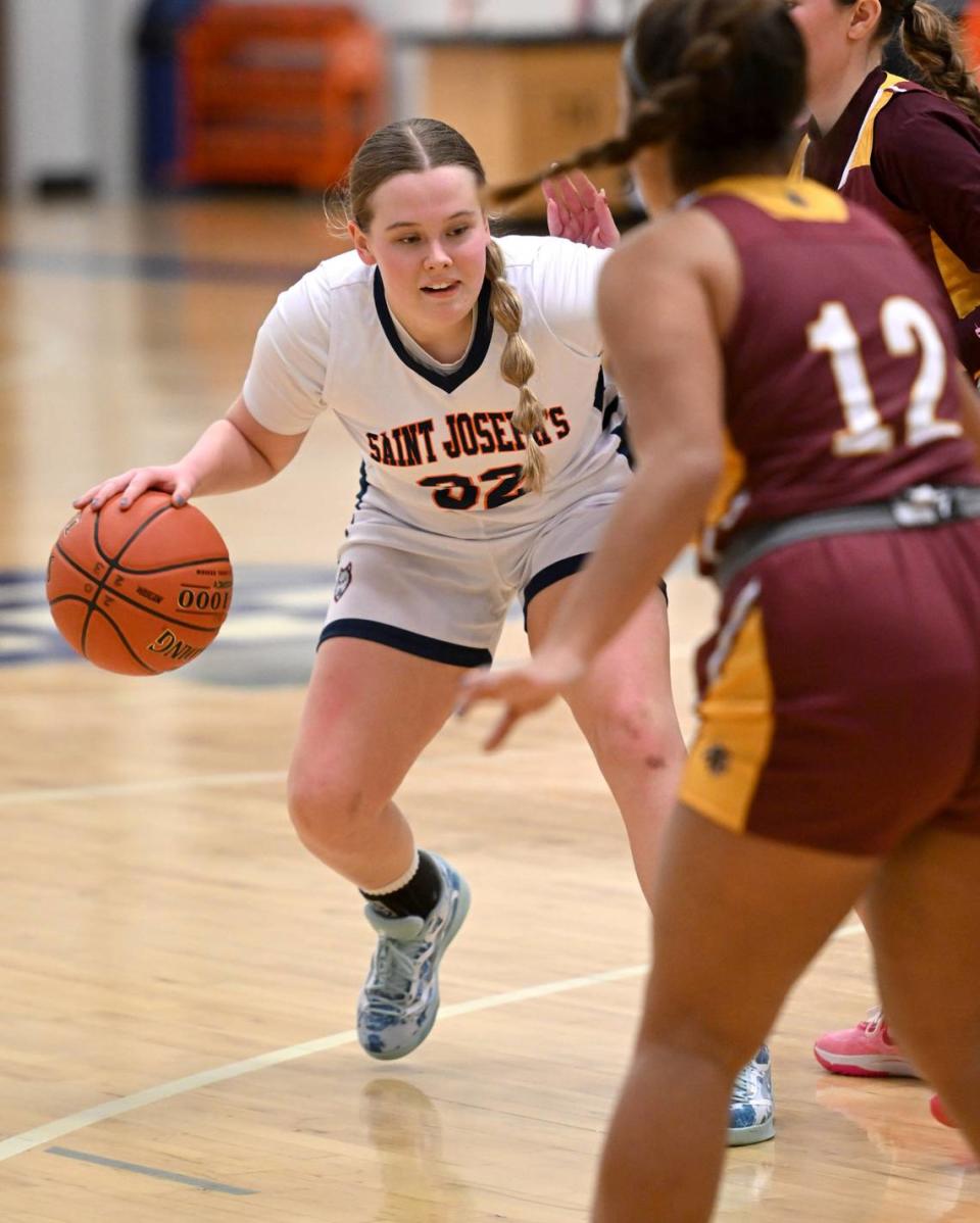 Saint Joseph’s Lauren Himes dribbles around Millersburg defenders during the game on Wednesday, Jan. 17, 2024.