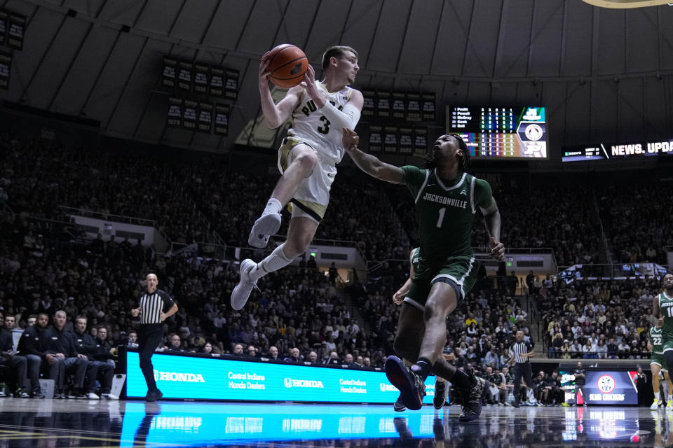 Purdue guard Braden Smith (3) makes a pass over Jacksonville forward DeeJuan Pruitt (1) during the second half of an NCAA college basketball game in West Lafayette, Ind., Thursday, Dec. 21, 2023. (AP Photo/Michael Conroy)