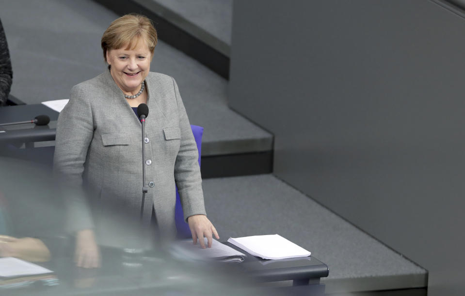 German Chancellor Angela Merkel smiles before she takes questions as part of a meeting of the German parliament, Bundestag, at the Reichstag building in Berlin, Germany, Wednesday, Dec. 18, 2019. (AP Photo/Michael Sohn)