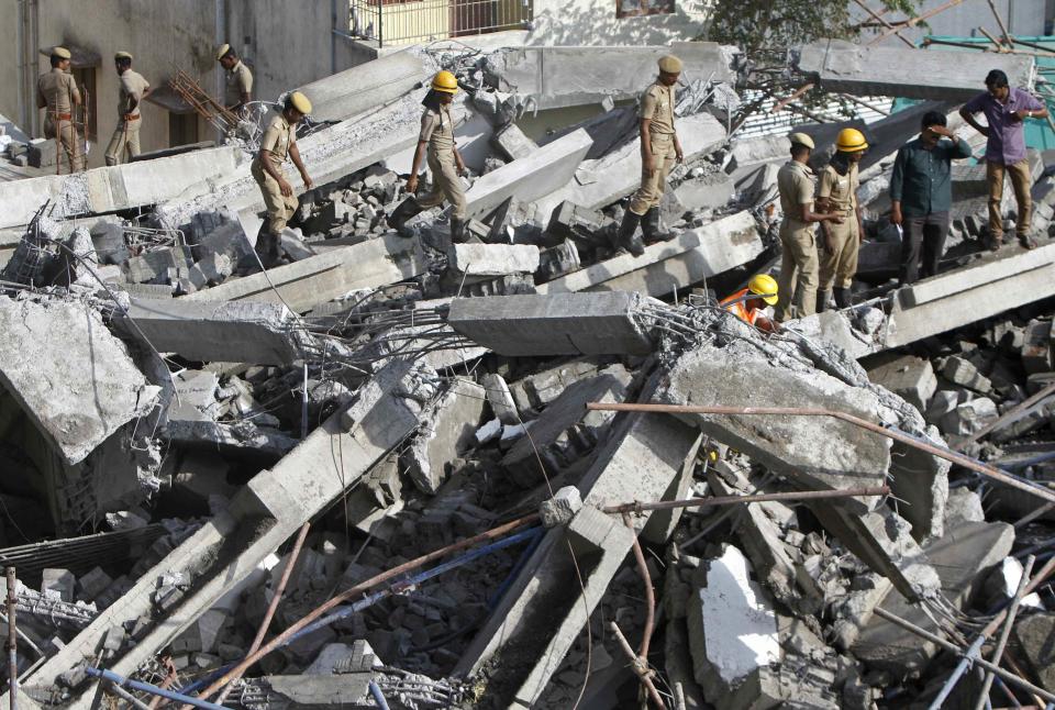 Rescue workers conduct a search operation for survivors at the site of a collapsed 11-storey building that was under construction on the outskirts of Chennai