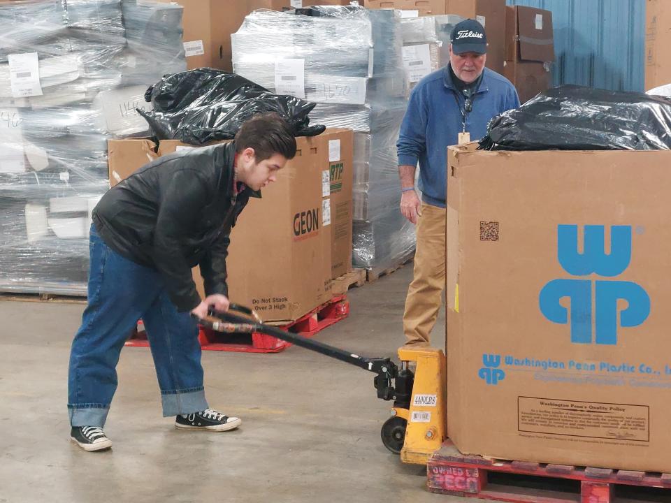 Pickaway-Ross Career and Technology Center Volunteer Coordinator Kim Graves shows a student how to use a forklift at Goodwill's warehouse in Chillicothe.