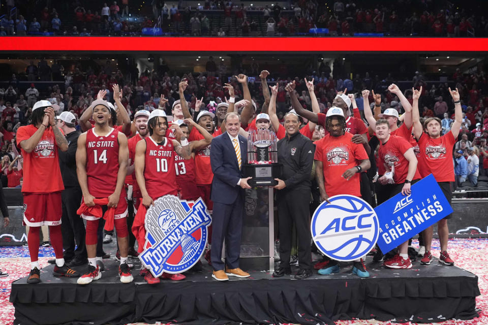 North Carolina State with the trophy after winning an NCAA college basketball game against North Carolina to win the championship of the Atlantic Coast Conference tournament, Saturday, March 16, 2024, in Washington. North Carolina State won 84-76. (AP Photo/Alex Brandon)